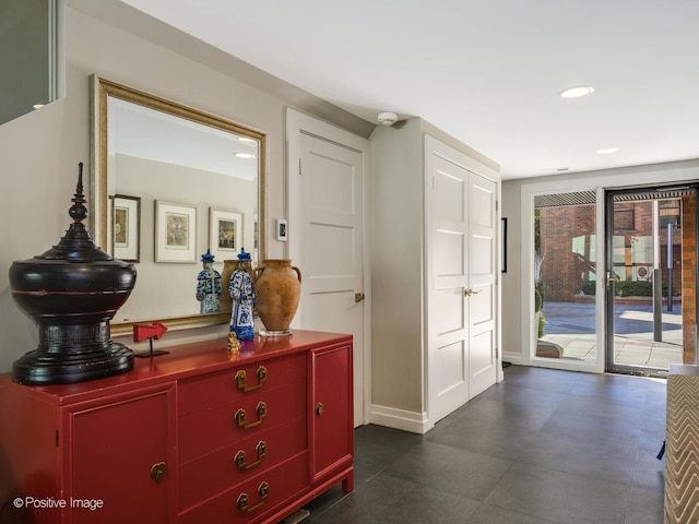 corridor featuring baseboards and recessed lighting