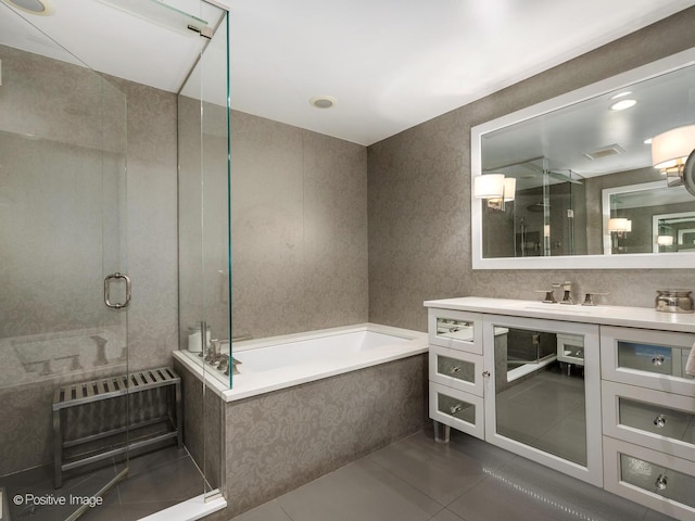 full bathroom featuring a garden tub, a shower stall, tile patterned flooring, and vanity