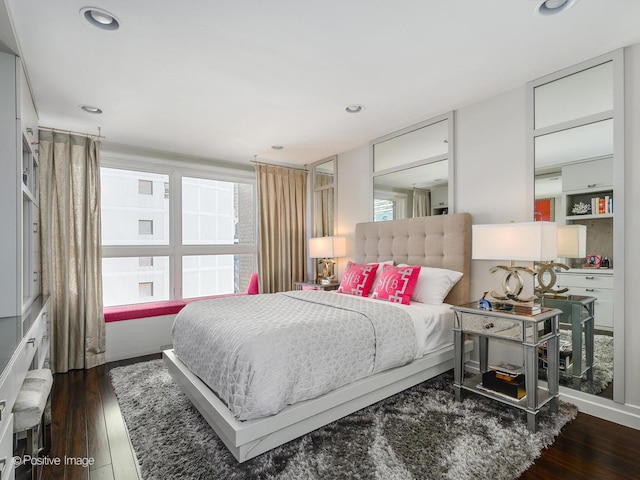 bedroom with dark wood-style floors and recessed lighting