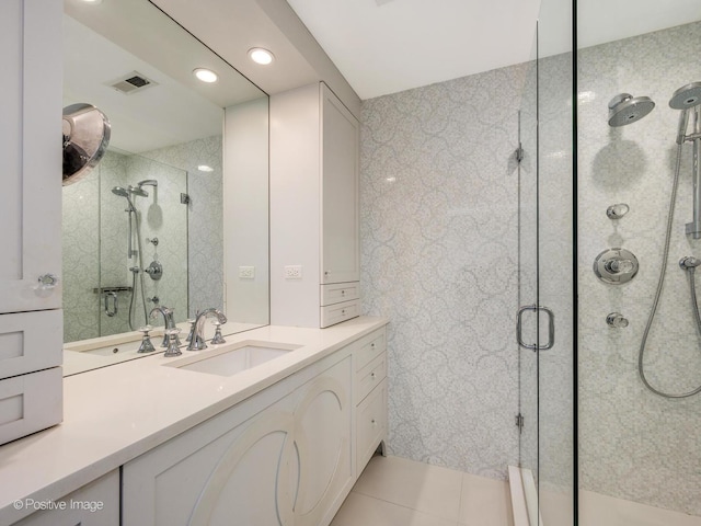 bathroom with visible vents, a shower stall, vanity, and tile patterned floors