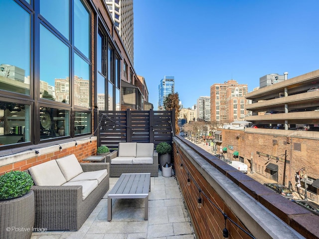 balcony with an outdoor living space and a city view