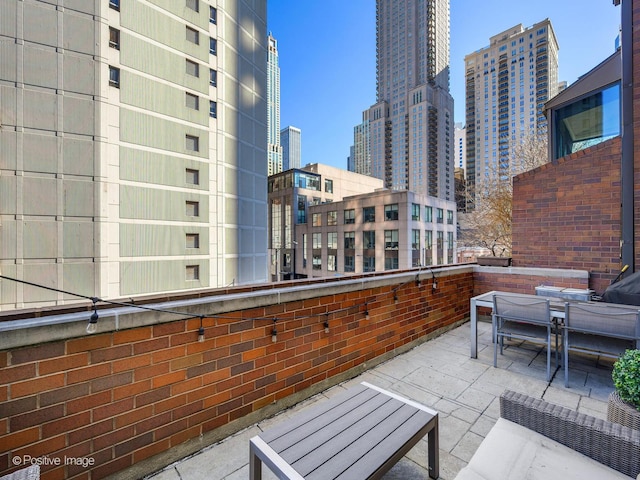 balcony featuring a city view and a patio