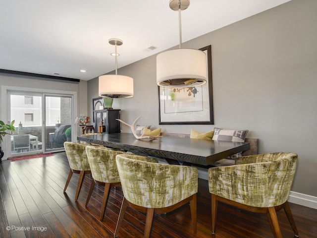 dining room featuring baseboards, visible vents, and wood finished floors