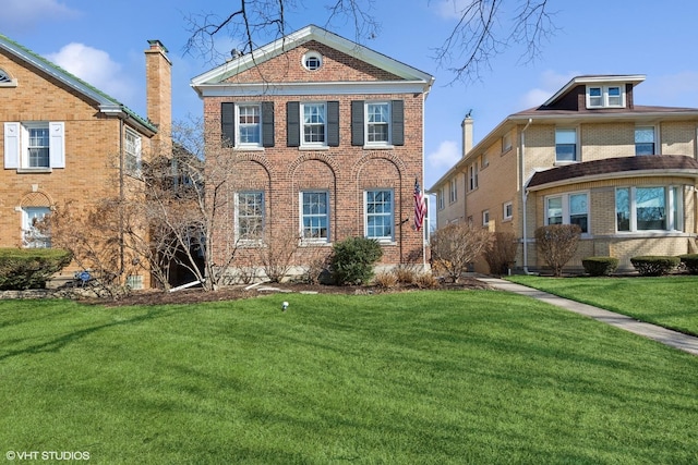 view of front of property with brick siding and a front yard