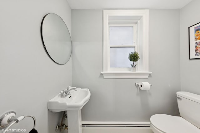 bathroom featuring a baseboard radiator and toilet