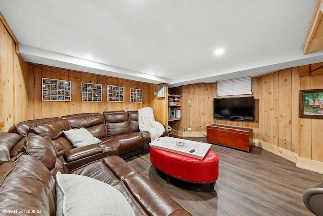 living room featuring recessed lighting, wood walls, baseboards, and wood finished floors