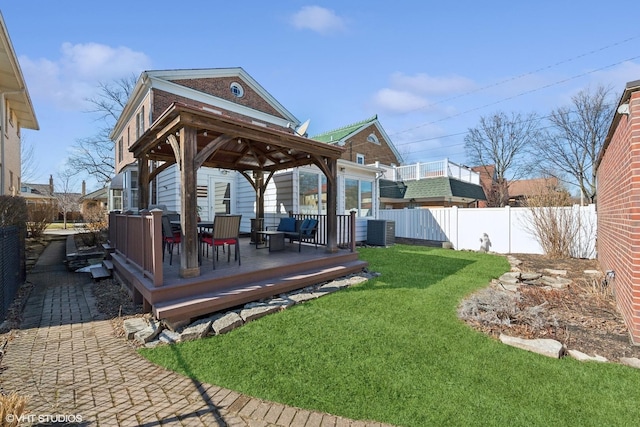 view of yard with a deck, a gazebo, fence, and central air condition unit