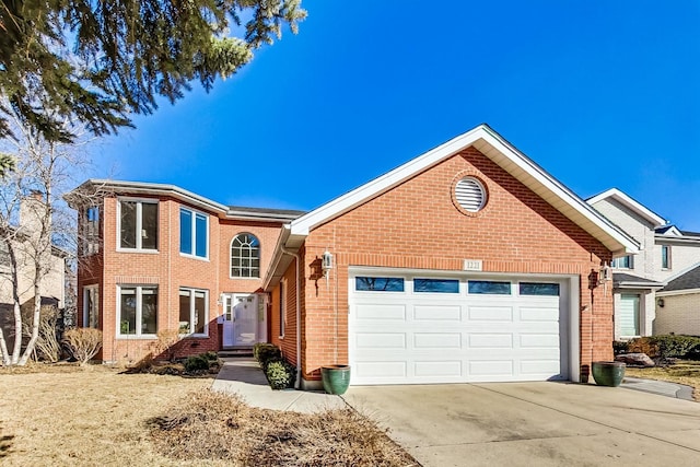 traditional home with a garage, driveway, and brick siding