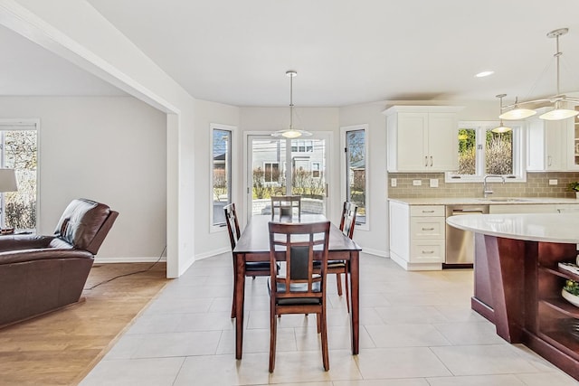 dining room featuring light tile patterned floors, baseboards, and recessed lighting