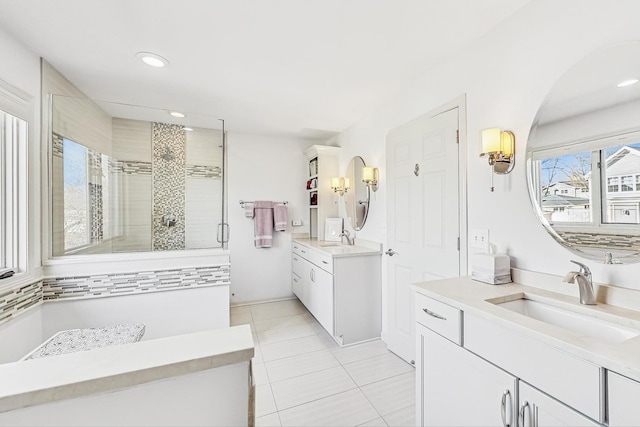 full bathroom with recessed lighting, two vanities, a stall shower, a sink, and tile patterned flooring