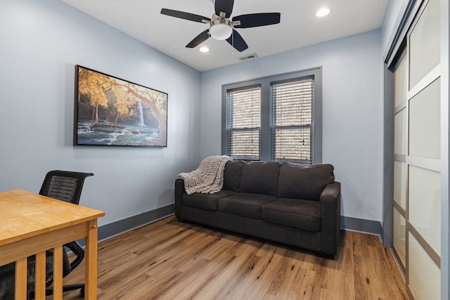 living room featuring visible vents, baseboards, a ceiling fan, light wood-style flooring, and recessed lighting