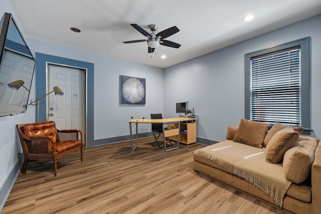 office space featuring light wood-type flooring, baseboards, a ceiling fan, and recessed lighting