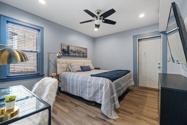 bedroom featuring ceiling fan, wood finished floors, and recessed lighting