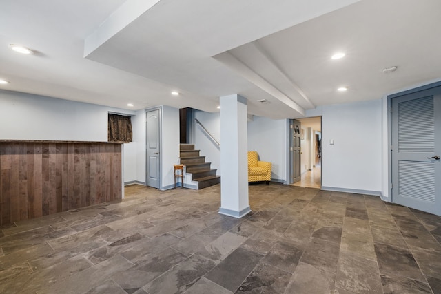 finished basement with stairs, baseboards, and recessed lighting