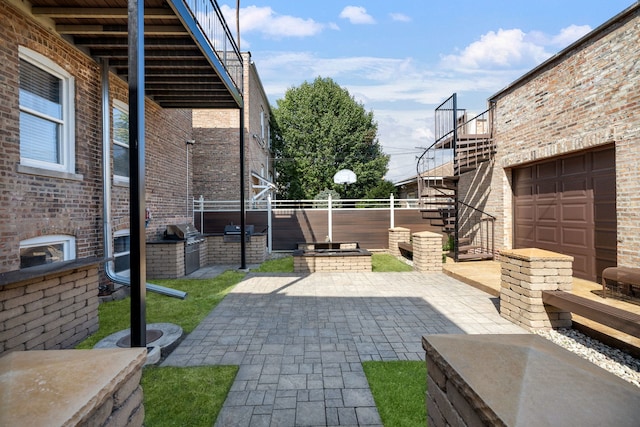 view of patio / terrace featuring stairs, area for grilling, and fence