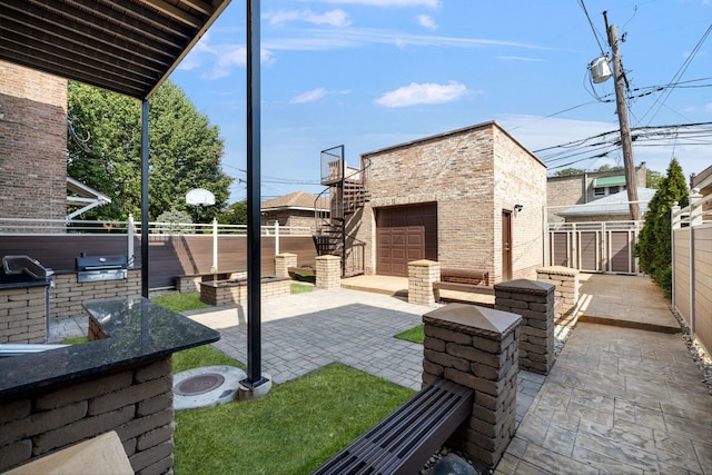 view of patio / terrace with a fire pit, an outdoor structure, a fenced backyard, and area for grilling