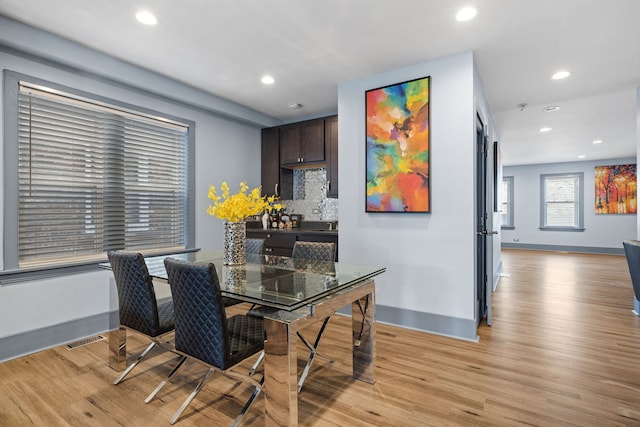 dining room featuring light wood-type flooring, visible vents, and recessed lighting