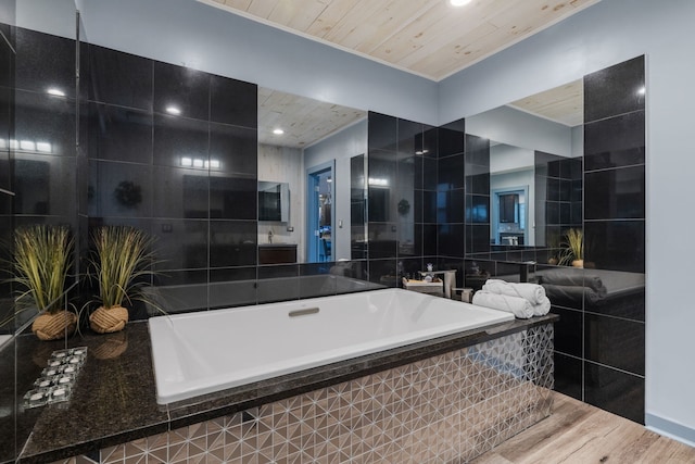 full bath with tiled tub, wooden ceiling, wood finished floors, and tile walls