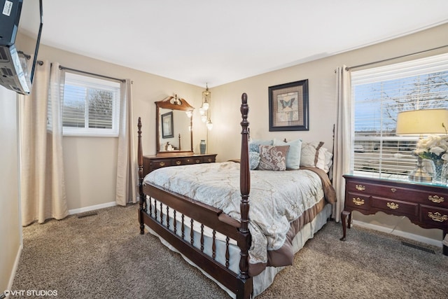 bedroom featuring carpet floors, multiple windows, visible vents, and baseboards