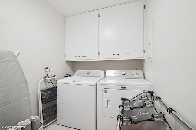 washroom with separate washer and dryer and cabinet space