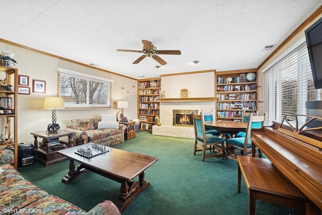 living room featuring carpet flooring, visible vents, built in features, ornamental molding, and a brick fireplace