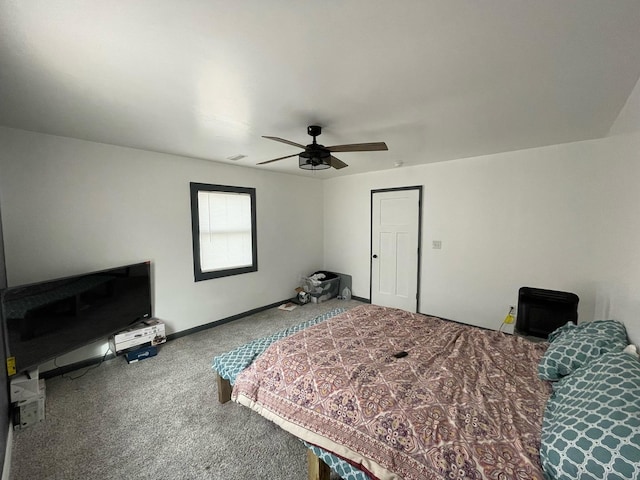 carpeted bedroom featuring ceiling fan, visible vents, and baseboards