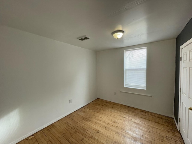 unfurnished bedroom with light wood-style floors and visible vents