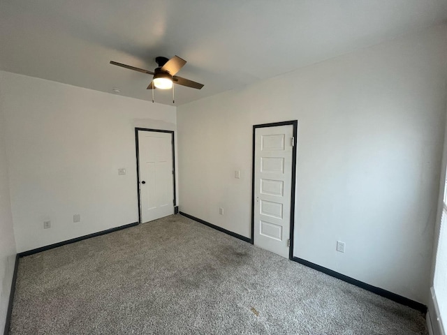 unfurnished bedroom featuring carpet floors, baseboards, and a ceiling fan