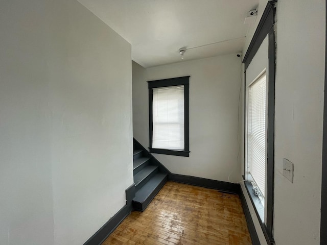 unfurnished room with hardwood / wood-style flooring and baseboards