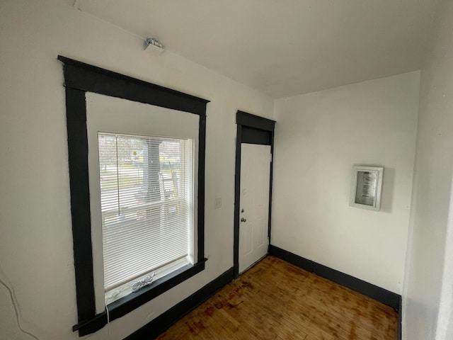 unfurnished room featuring wood finished floors and baseboards