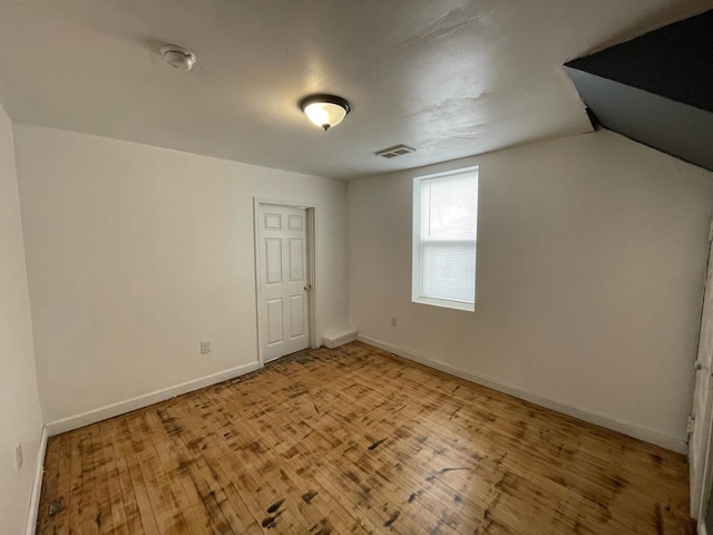 interior space featuring baseboards, visible vents, and light wood finished floors