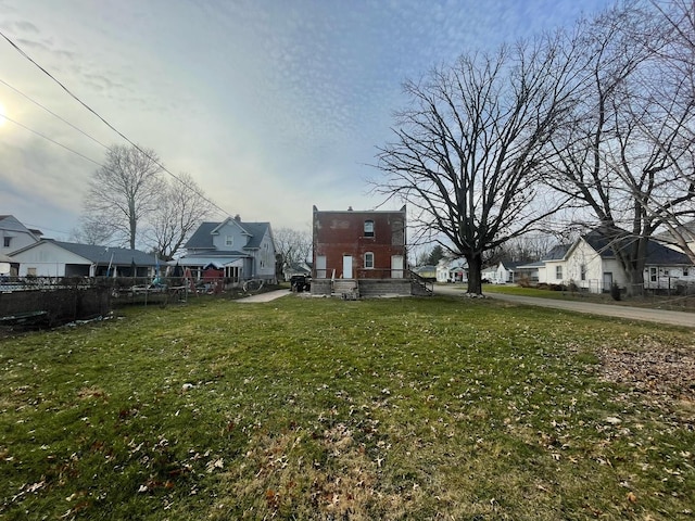 view of yard with a residential view and fence