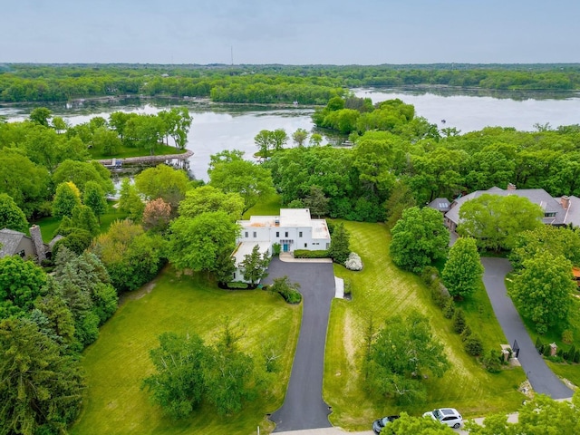 drone / aerial view featuring a water view and a forest view