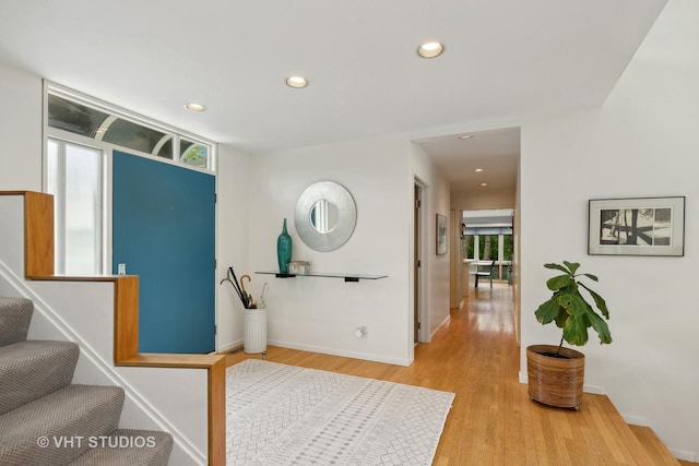 foyer entrance with stairs, baseboards, wood finished floors, and recessed lighting