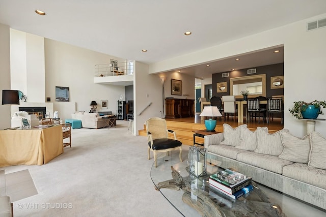 living area with carpet, visible vents, and recessed lighting