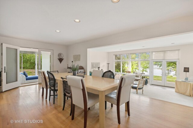 dining room featuring light wood finished floors, recessed lighting, and french doors