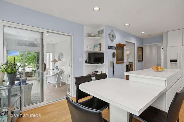 dining room featuring light wood finished floors, visible vents, and recessed lighting