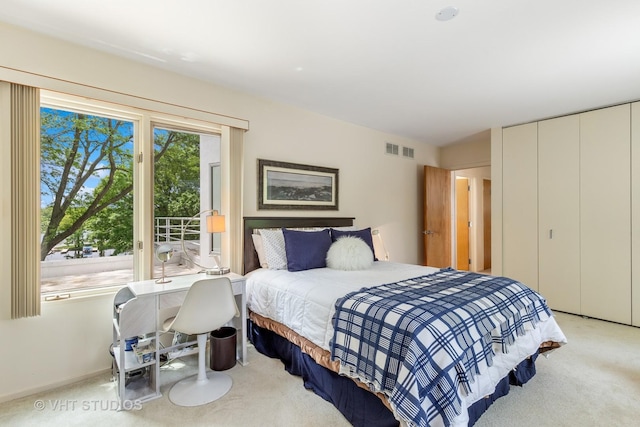 bedroom featuring light carpet, baseboards, visible vents, access to exterior, and a closet