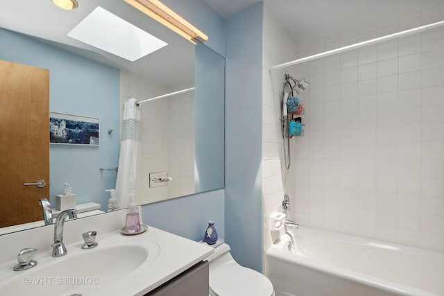 full bathroom featuring a skylight, shower / bathtub combination with curtain, toilet, and vanity