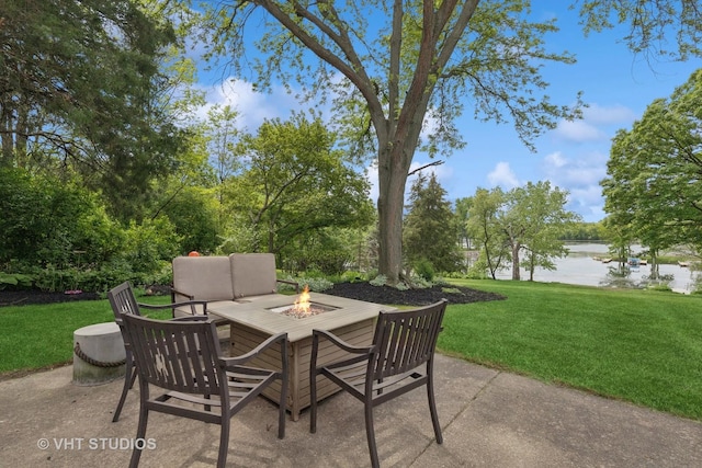 view of patio featuring an outdoor fire pit and a water view