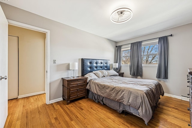 bedroom featuring light wood-type flooring and baseboards