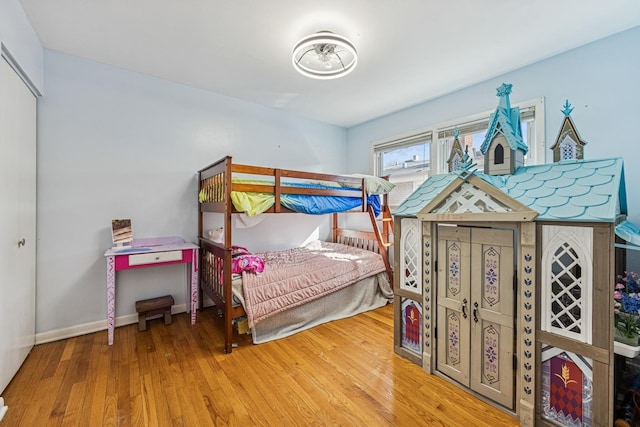 bedroom with baseboards and wood finished floors