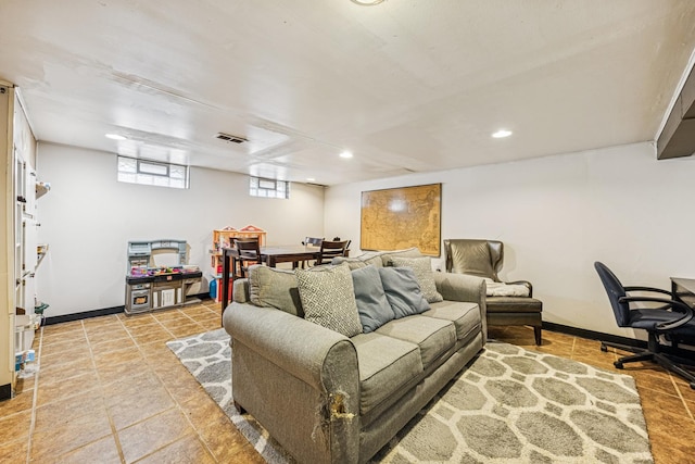 living area with baseboards, visible vents, and recessed lighting