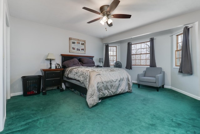 bedroom featuring baseboards, dark carpet, and a ceiling fan