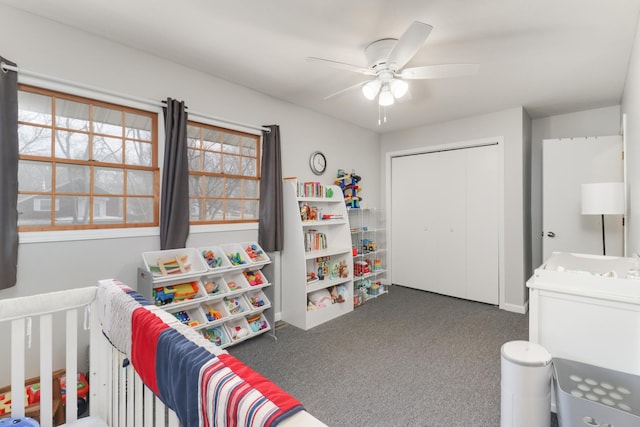 bedroom with dark colored carpet, a closet, and ceiling fan