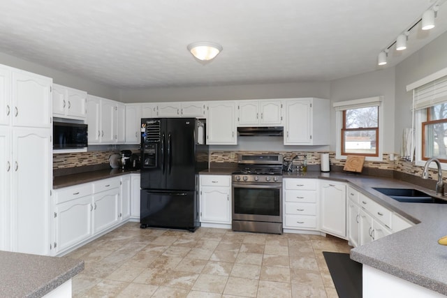 kitchen featuring black refrigerator with ice dispenser, white cabinets, stainless steel gas stove, a sink, and under cabinet range hood