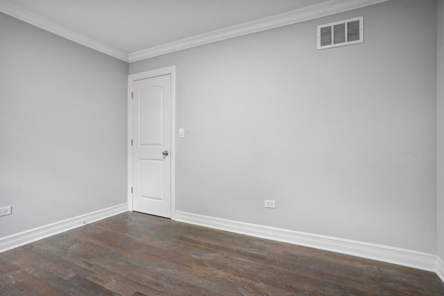 spare room featuring baseboards, crown molding, visible vents, and dark wood-type flooring