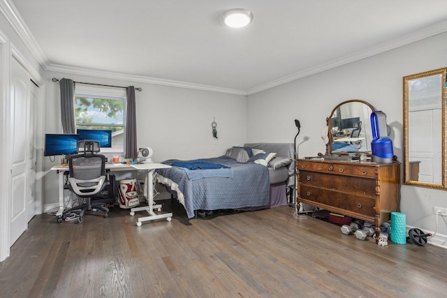 bedroom with ornamental molding and wood finished floors