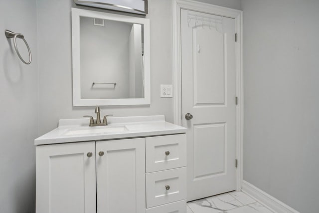 bathroom featuring visible vents, marble finish floor, vanity, and baseboards