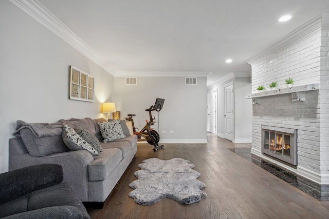 living room with a fireplace, crown molding, and wood finished floors